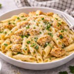 Creamy garlic chicken pasta with parmesan and parsley in a bowl