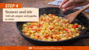 Seasoning potatoes with salt pepper and paprika in skillet for egg and potato skillet recipe step 4