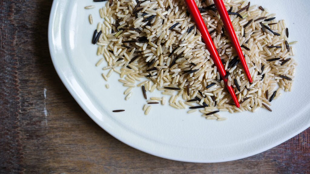 Cooked wild rice with dark grains and chewy texture on a plate