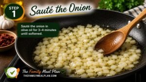 Diced onion sautéing in olive oil in a large skillet for Creamy Tuscan White Bean Skillet.